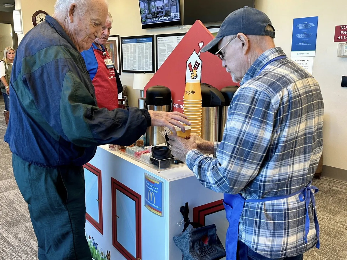 People sharing refreshments at a Ronald McDonald House Care Cart.
