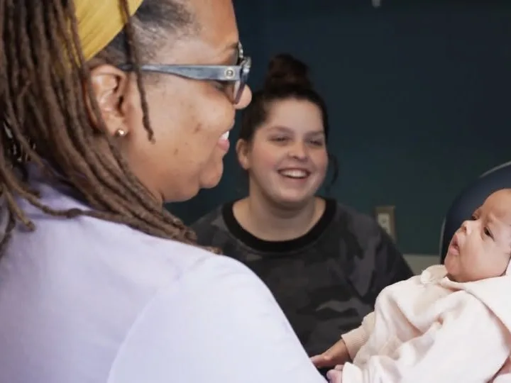 Care Mobile staff member with a parent and infant.