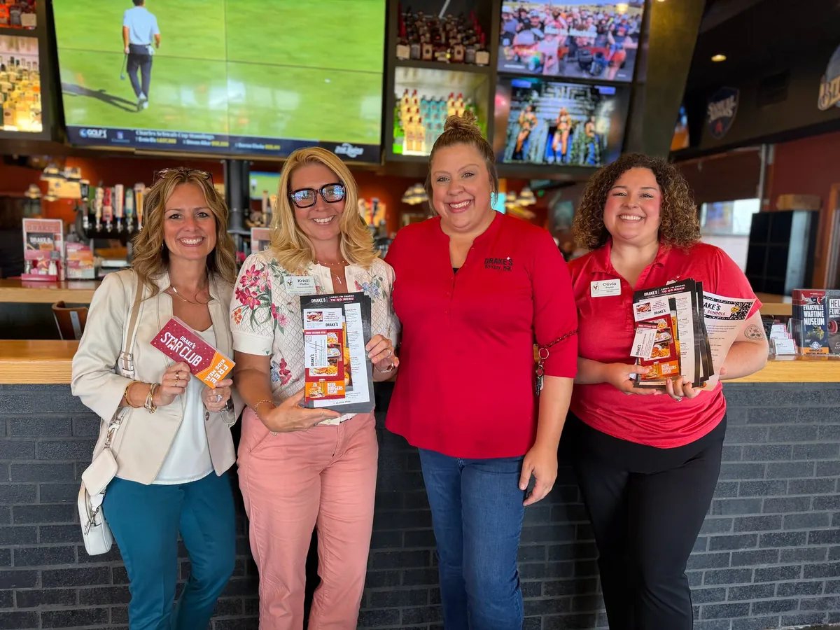 Business partners holding donated products.