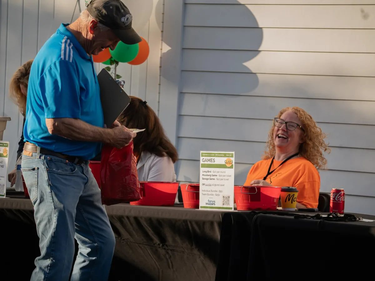 Event sponsors and volunteers at a check-in table.