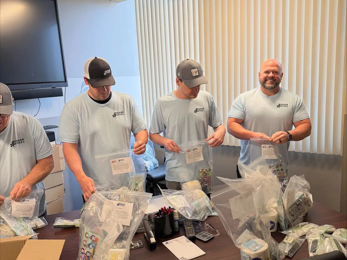 Sugar Steel employees packing supply kits together.