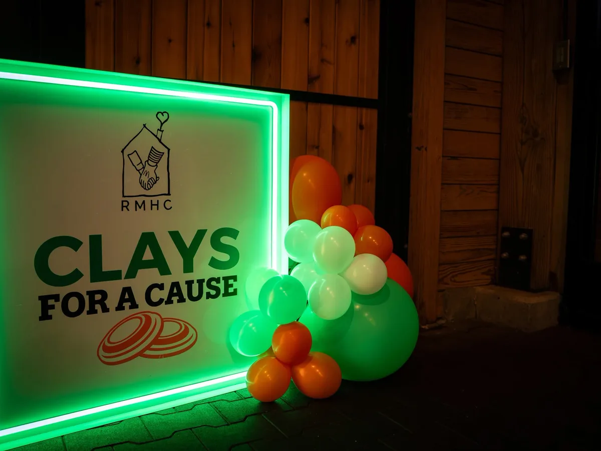 Clays for a Cause event sign and balloons.
