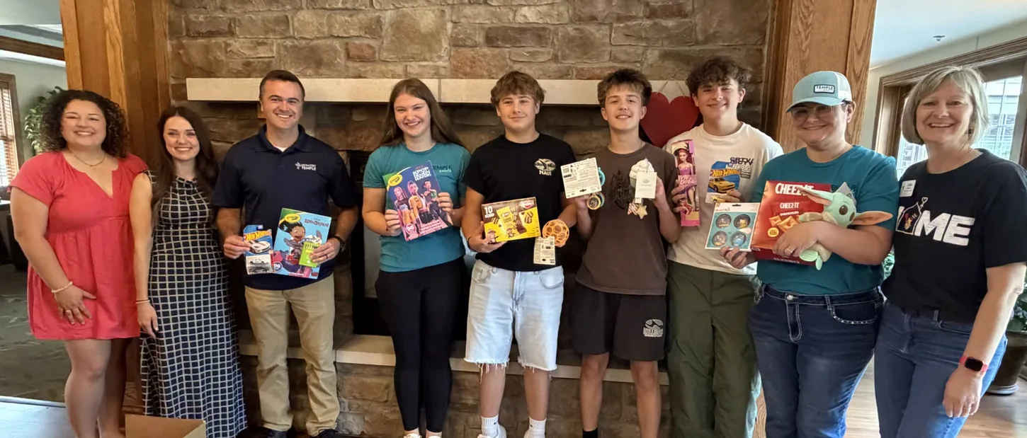 Methodist Temple volunteers with donated toys at Ronald McDonald House.