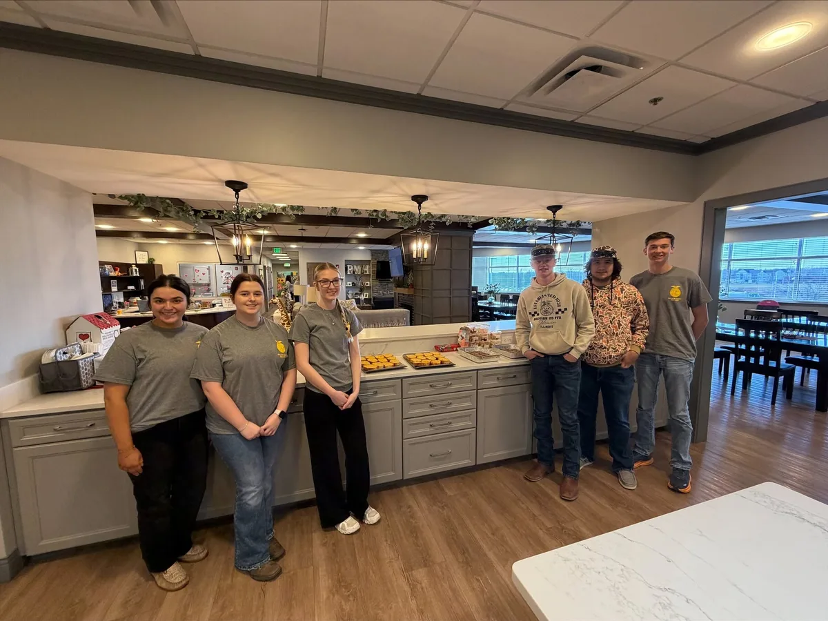 Volunteers with a prepared meal in the House kitchen.