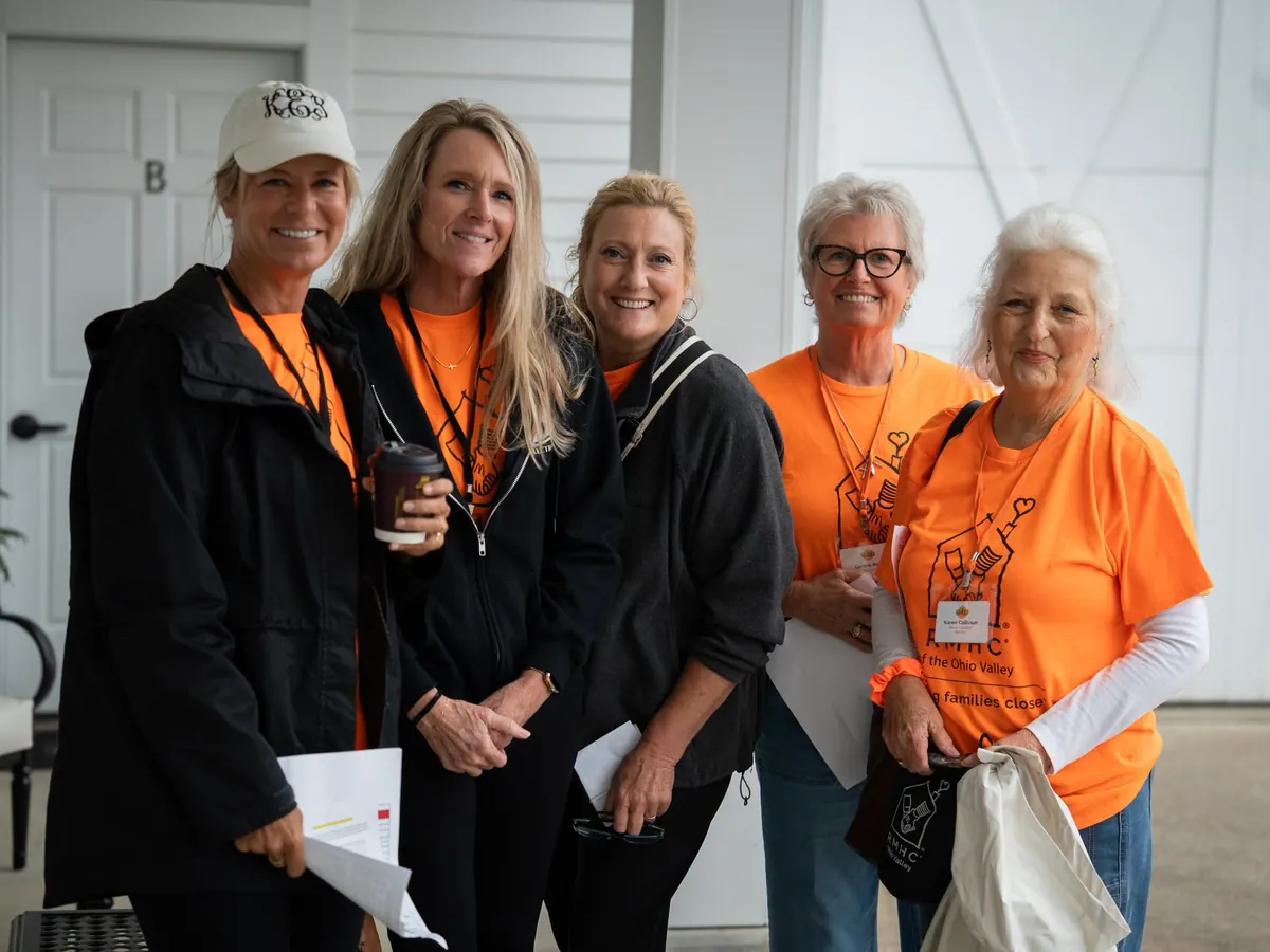 Event volunteers in orange shirts at Clays for a Cause.