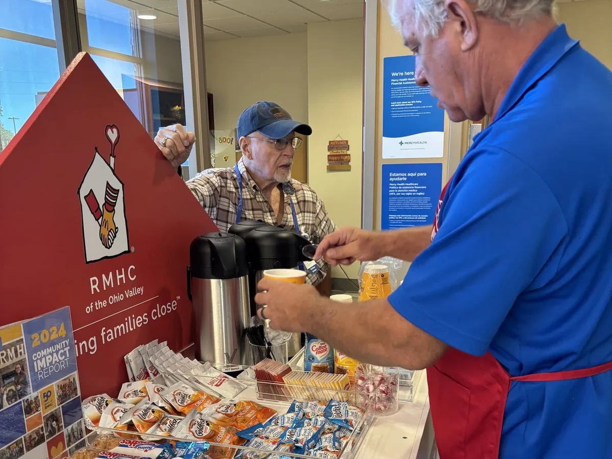 A Care Cart volunteer serving coffee and snacks at the hospital.
