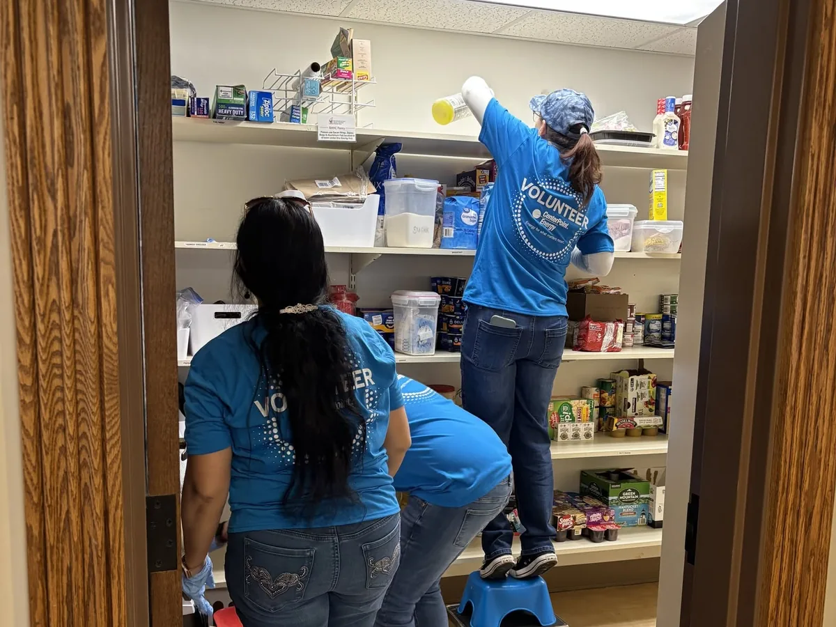 Volunteers organizing pantry shelves at the House.
