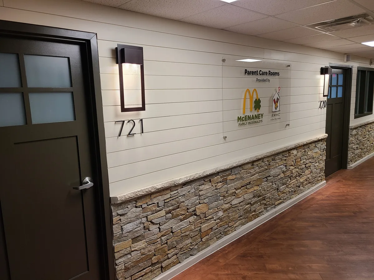 Hospital corridor with entrances and signage for Parent Care Rooms.