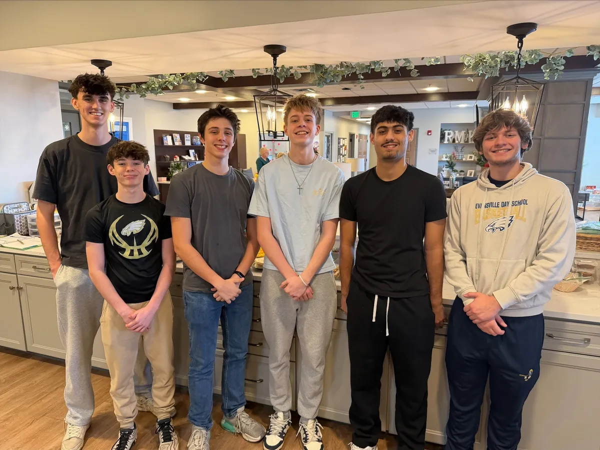 A group of student volunteers in the House kitchen.